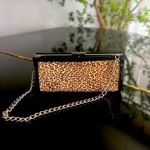 Clutch covered in PONY FUR. Never used, leopard print used with or without chain